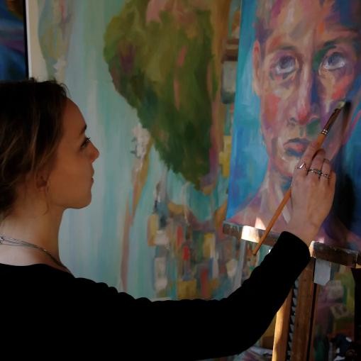 Vanessa painting
        in her studio.